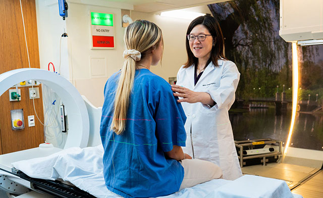 Helen Shih, MD with patient in the proton center.