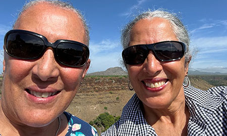 Flora (right) and her sister exploring their roots in Cape Verde, four months after Flora’s surgery in October 2022.