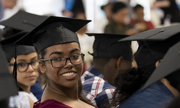An MGH Youth Program graduate looks back and smiles while wearing her graduation cap. An MGH Youth Program graduate looks back and smiles while wearing her graduation cap.